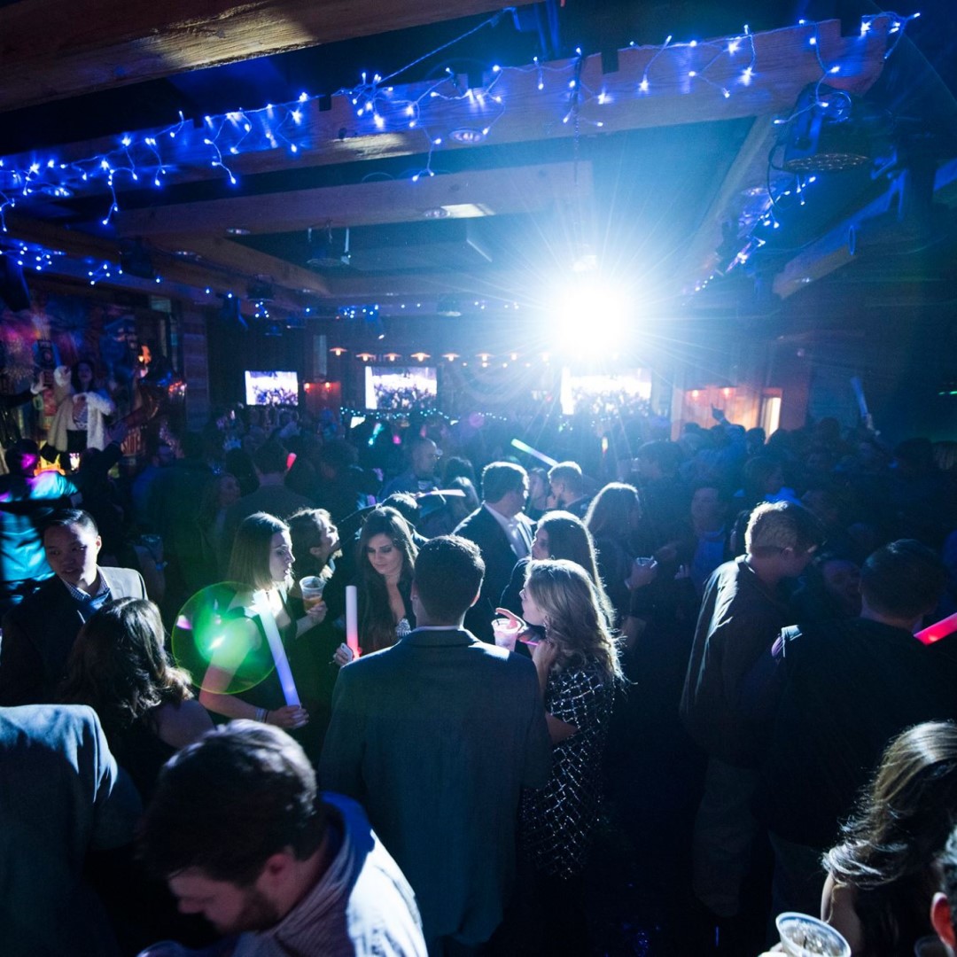 DJ playing for a crowd at a New Year's Eve party.